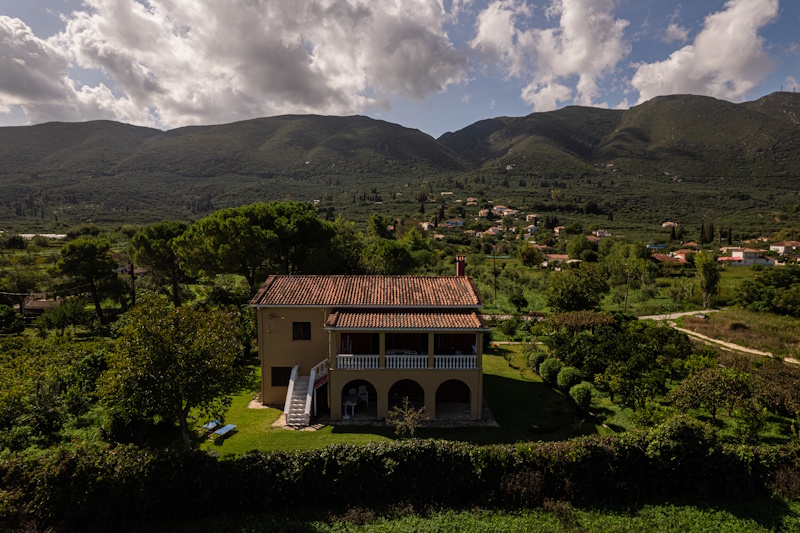 Front view of Selini Villa in Kalithea with mountain and countryside backdrop