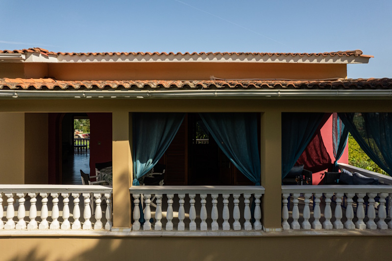 Balcony of Selini Villa in Kalithea with seating area and curtains