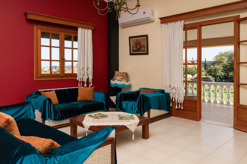Living room with seating area and balcony doors at Selini Villa in Kalithea