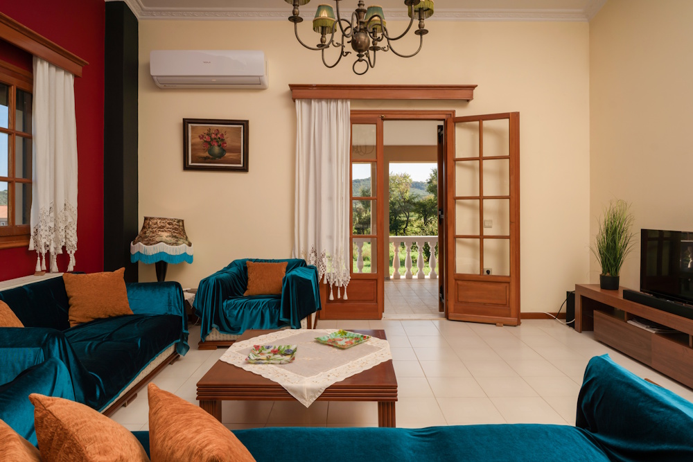 Living room with balcony access at Selini Villa in Kalithea