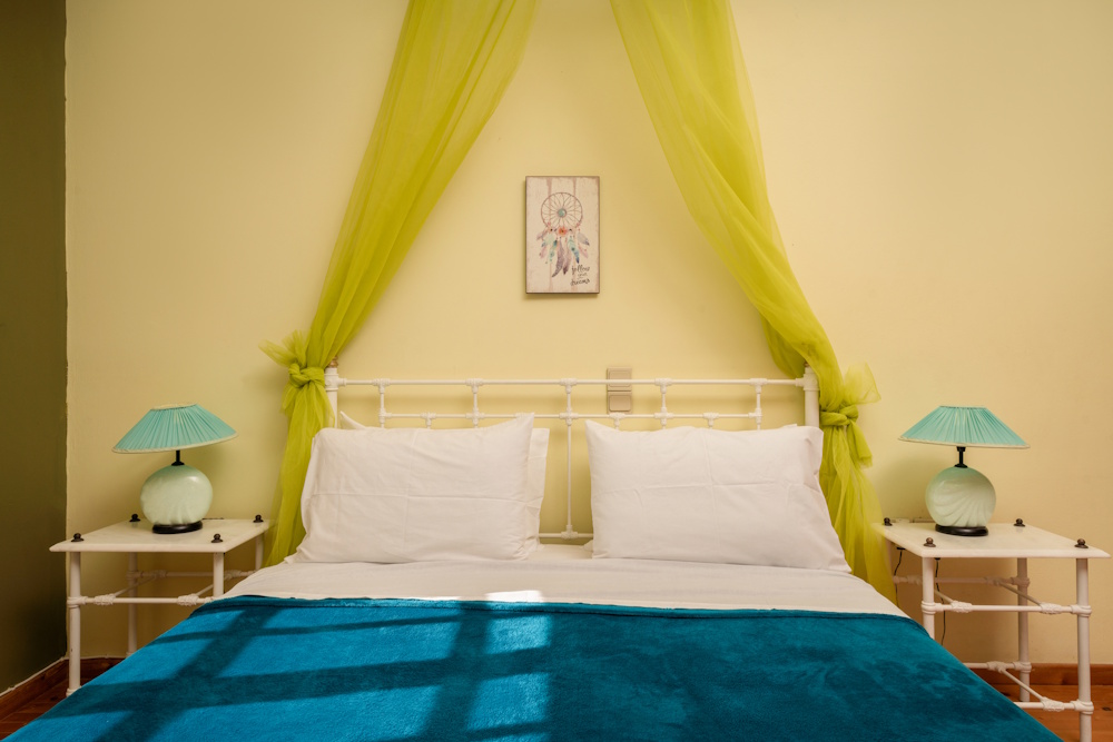 Double bed with soft decor at Selini Villa in Kalithea