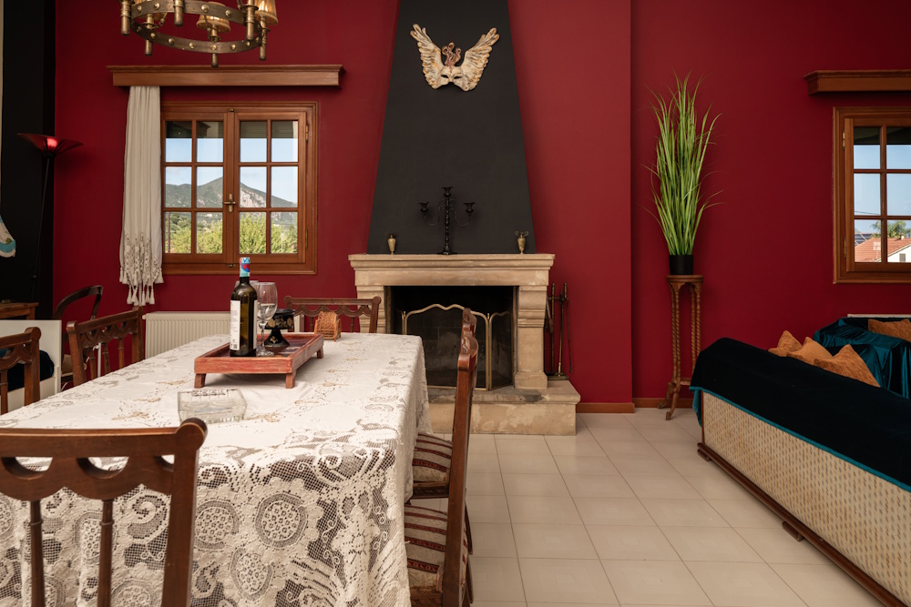 Dining area with fireplace detail at Selini Villa in Kalithea