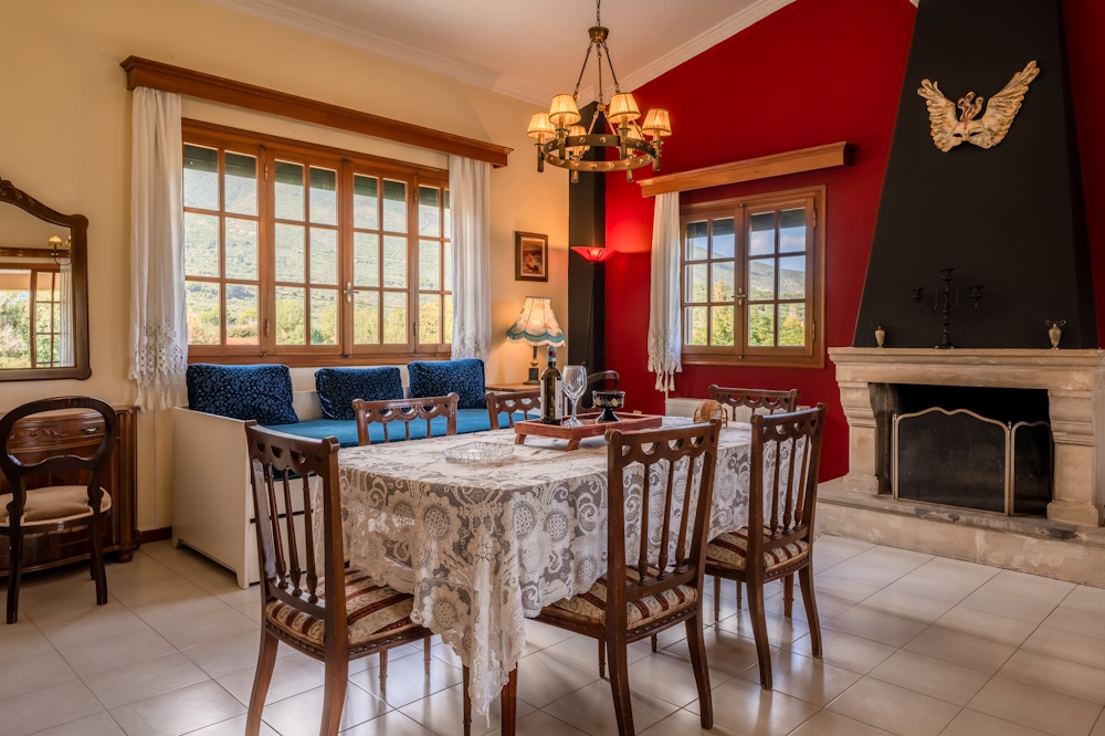 Dining room with fireplace at Selini Villa in Kalithea