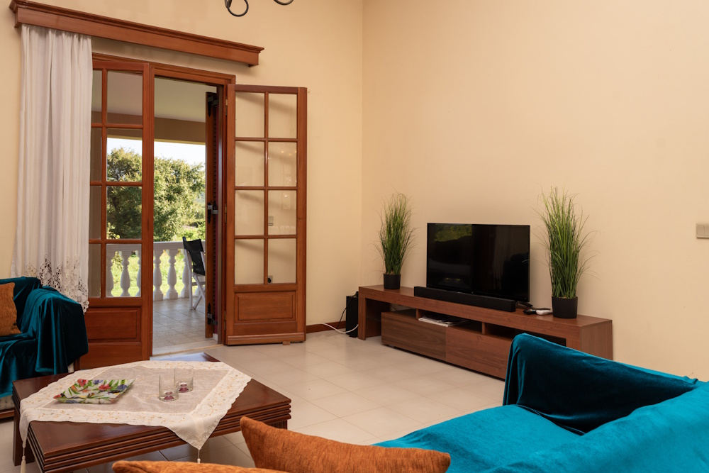 Living room with balcony access at Selini Villa in Kalithea