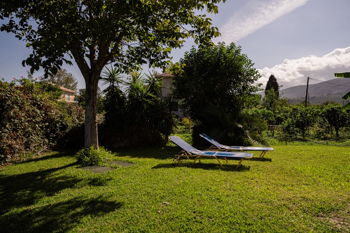 Garden area with sun loungers at Selini Villa in Kalithea