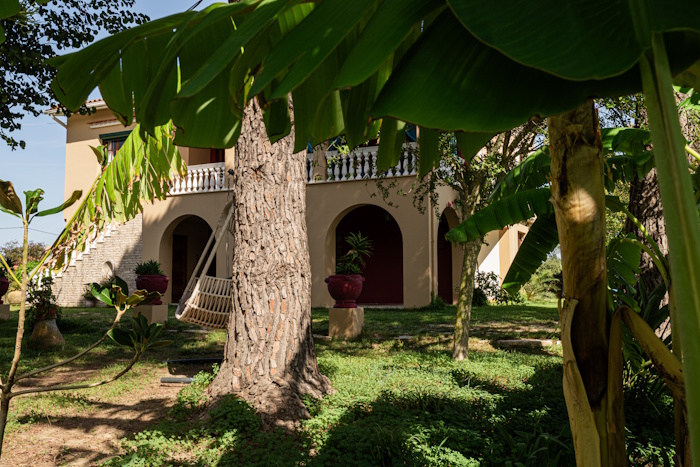 Garden view of Selini Villa in Kalithea with trees and shaded outdoor area